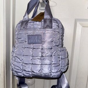 Steve Madden puffy Backpack, guitar straps and a zipper pockets on the side.